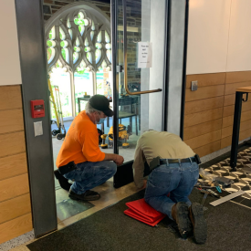 two technicians fixing the automatic door