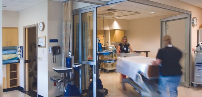 hospital bed passing through a hospital door